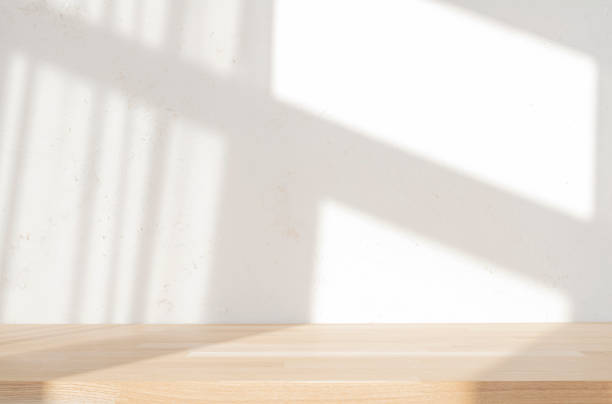 istock Product presentation wooden table on blur abstract texture cement wall with soft sun light window shadow background 2202430798