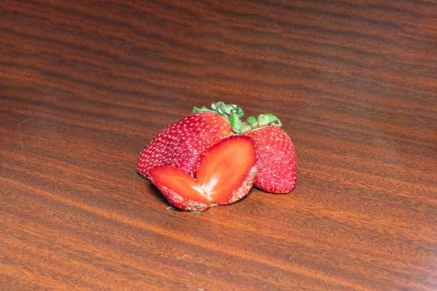 istock Strawberries with leaf on wooden background. 2202431116