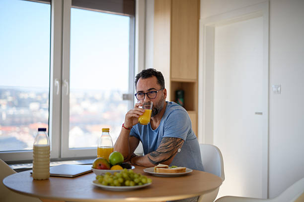 istock Diabetic man with CGM sensor having healthy breakfast. 2202431207