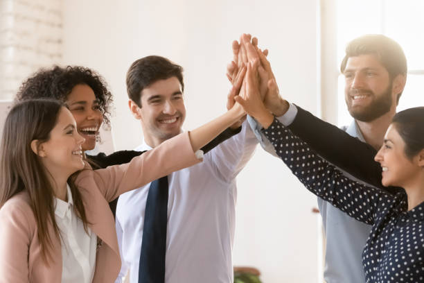 istock Group of people standing together, give each other high five 2202433322