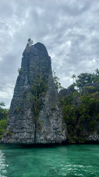 istock Triangular shaped rocks and azure clear water near Misool Island in Raja Ampat, Indonesia, ecotourism concept 2202433743