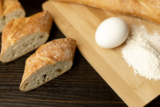 Flour, egg, rolling pin close-up.Bread in clay plate.The process of making bread
