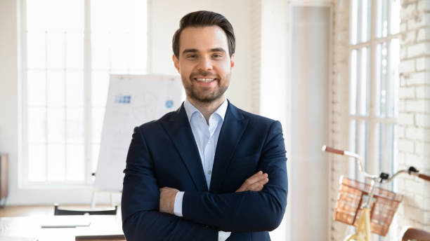 istock Confident, professional businessman dressed in formal jacket posing in boardroom 2202434742