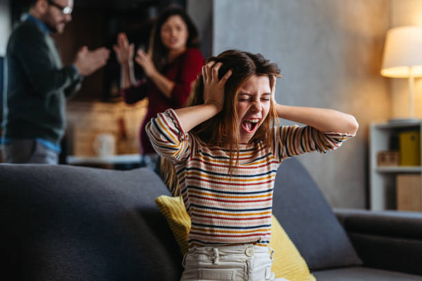 istock A neglected, frustrated teenager while her parents struggle with relationship problems and argue 2202436300