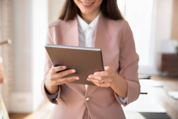istock Cropped closeup shot female employee using digital tablet 2202436371