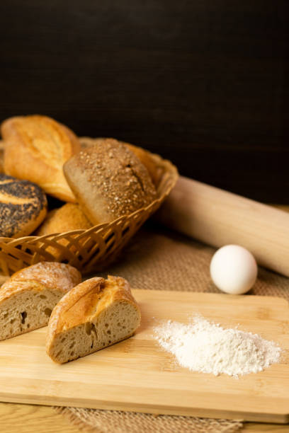 Sliced bread on the table, flour, egg. Homemade pastries. Freshly baked buns are on the table. The process of baking bread. High quality photo