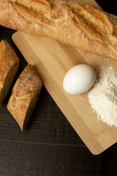 Slices of sliced bread on the table.Flour, egg, bread close-up.Homewort pastries