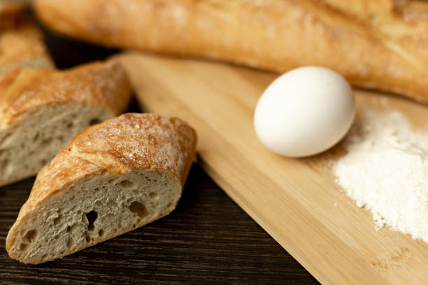 Slices of sliced bread on the table.Flour, egg, bread close-up.Homewort pastries