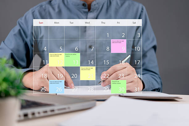 Businessman planning schedule with a digital calendar interface. Concept of time management, productivity, organization, task scheduling, and goal setting for business success and efficiency.