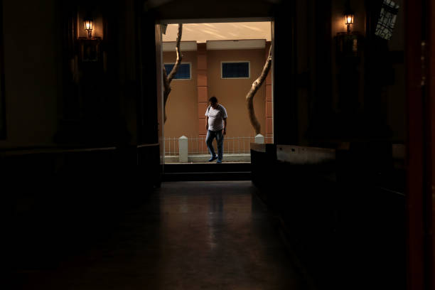 Dumaguete City, Negros Oriental, Philippines - February 27, 2025: A person coming inside the Cathedral Church to pray