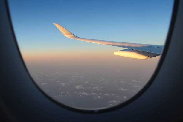 istock Airplane window view of sunset overlooking 2202441141