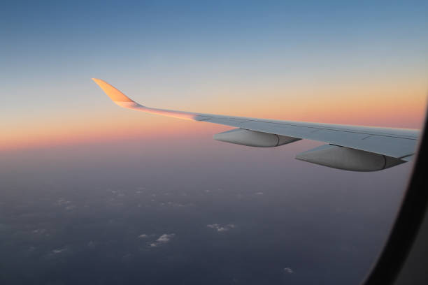 istock Airplane window view of sunset overlooking 2202441144