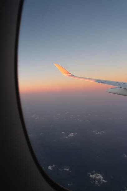 istock Airplane window view of sunset overlooking 2202441166