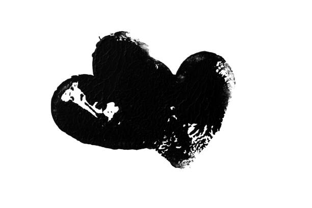 A monochromatic abstract heart shape with a rough, textured surface, resembling an ink or paint imprint on a white background. The high-contrast design and irregular patterns evoke a sense of depth and emotion, making it a striking visual element.