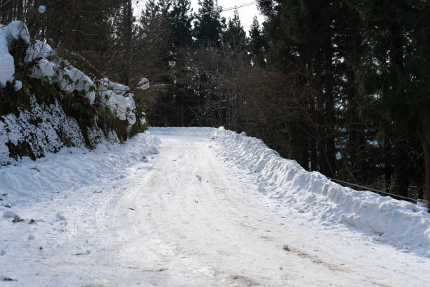 Snow moldboard along the mountain road. Japan winter. White background snow concept.