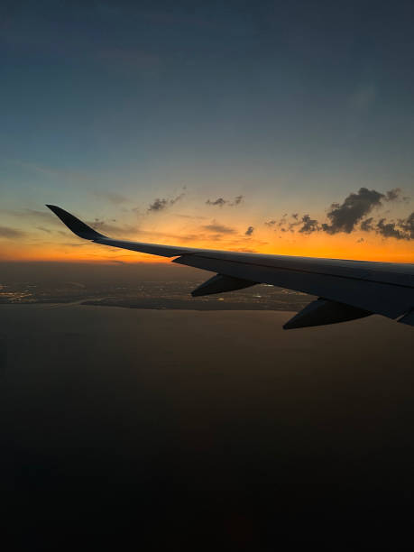 istock Airplane window view of sunset overlooking 2202442693