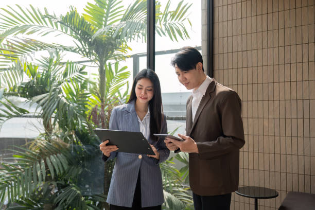istock Businesswoman organizing thoughts with sticky notes, smiling and engaged in teamwork. 2202445096