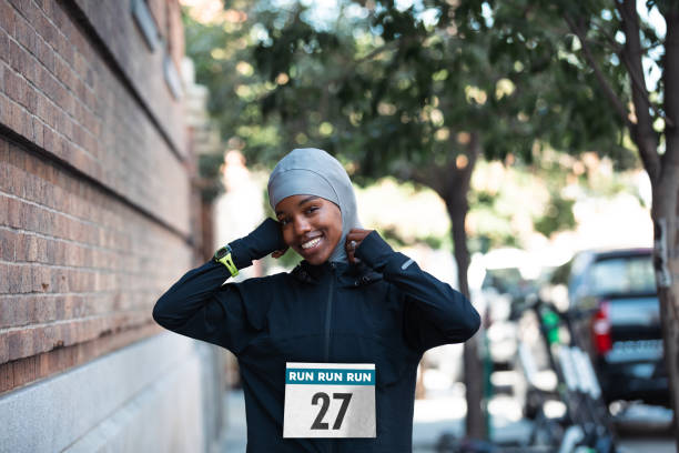 Sportswoman with hijab attending to a running event