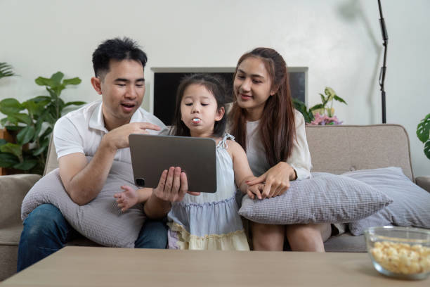 istock Family sharing a fun moment while watching a tablet, showcasing engagement and joy. 2202447205