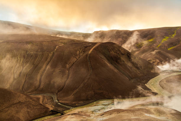 istock Misty geothermal valley with a winding river cutting through volcanic hills 2202448278
