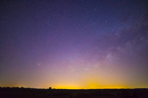 istock night starry sky with milky way above prairie silhouette 2202449066