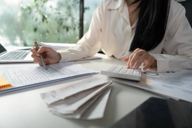 istock Person managing tax documents and checking information on a smartphone. 2202449270