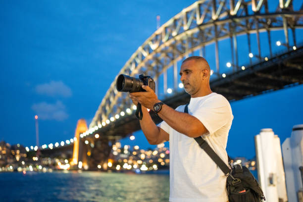 istock Photographer Capturing Night Scene at Sydney Harbour Bridge 2202449809