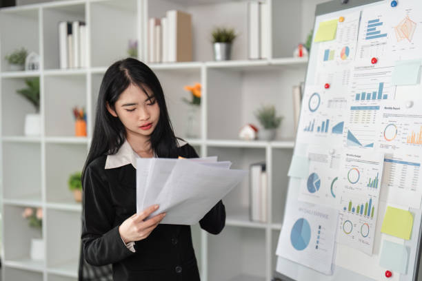 istock Accountant engaged in financial analysis and document preparation in a contemporary office. 2202450879