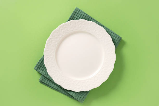 istock St Patrick's Day party table setting with green decoration on green background. 2202451072