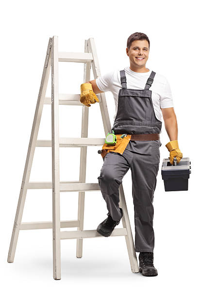 istock Repairman with a tool box standing next to a ladder 2202453046