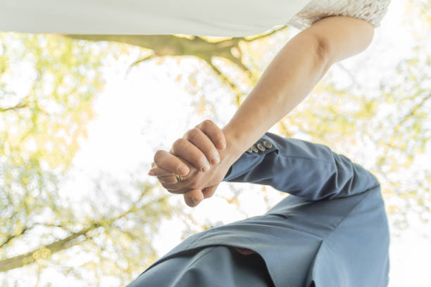 Playful Wedding couple in park