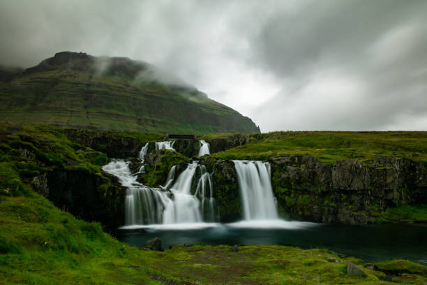 istock Majestic waterfall in misty mountain scenery 2202455153