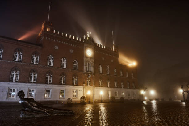 Night scenes in city covered in haze and fog. Townhall in Odense
