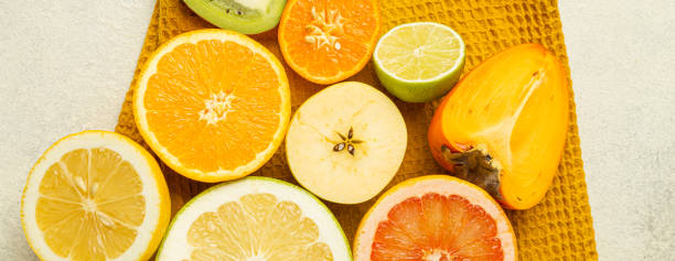 istock A bunch of fruit including oranges, lemons, and grapefruit are displayed on a table. The fruit is cut in half and arranged in a circle 2202456708