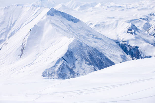 istock Beautiful Snow-Covered Mountains Under a Clear Blue Sky: A Serene Winter Landscape Capturing the Essence of Nature's Tranquility and Majestic Beauty in a Snowy Wilderness 2202457479
