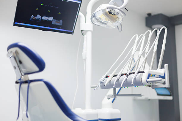 istock Modern Dental Clinic Equipment with High-Tech Tools and Bright Lighting Featuring a Comfortable Examination Chair and Advanced Treatment Monitor for Patient Care 2202459161