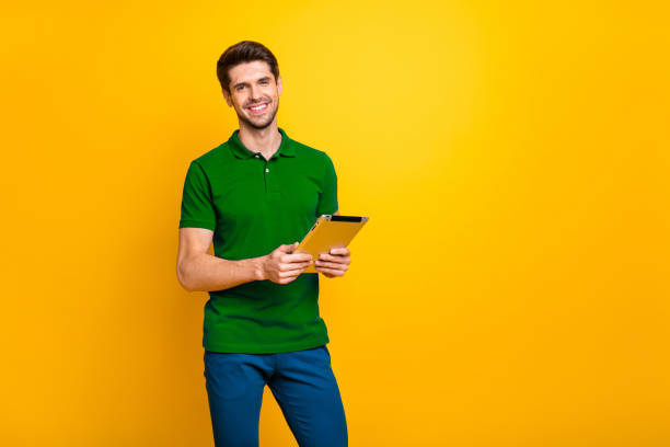 istock Portrait of his he nice attractive cheerful cheery content guy using digital ebook app browsing web wi-fi isolated over bright vivid shine vibrant yellow color background 2202459734