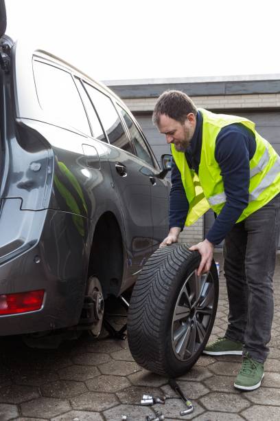 istock man demonstrates process of changing a tire, which is important for articles and materials about car maintenance. She emphasizes need for regular maintenance of the vehicle. Car Maintenance Repair 2202460365