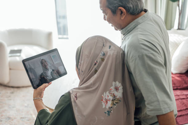 istock Staying Connected: An Asian Muslim Senior Couple Celebrates Hari Raya Aidilfitri Virtually 2202461016