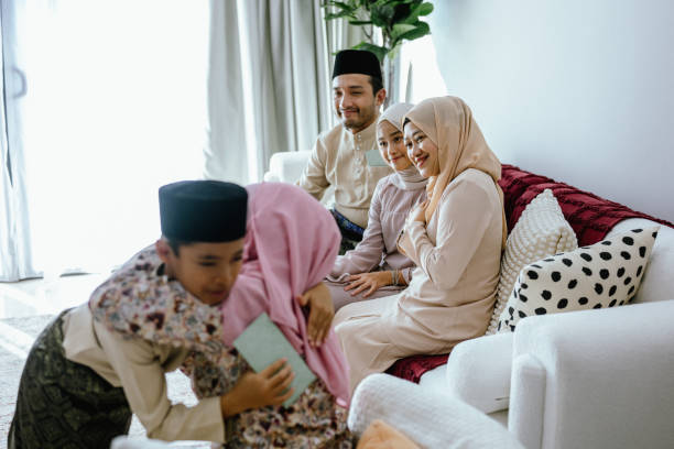 istock Raya Joy: A Young Boy Receives Blessings from His Parents on Hari Raya Aidilfitri 2202462902