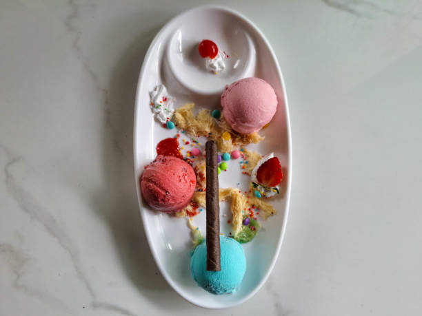 Delicious Ice Cream With Bubblegum Cream, Raspeberry Cream, Strawberry Cream, Whipped Cream, Cotton Candy, Chewing Gum Candy, Strawberry Fruit And Chocolate Stick. Dessert Food Menu. Top View.
