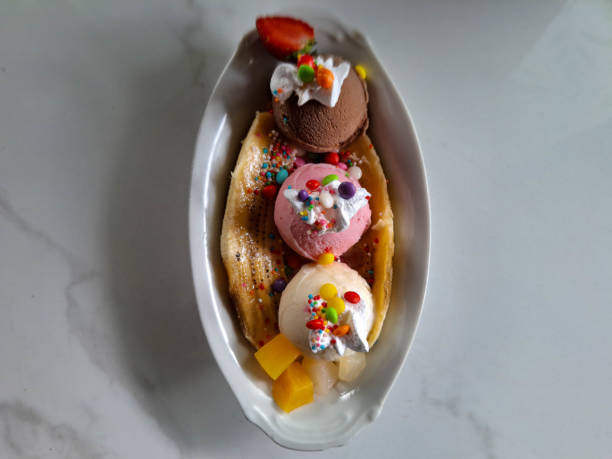 Delicious Banana Split Ice Cream With Banana, Strawberry, Mango, Whipped Cream, Candy, Chocolate Ice Cream, Strawberry Ice Cream And Vanilla Ice Cream. Dessert Food Menu. Top View.