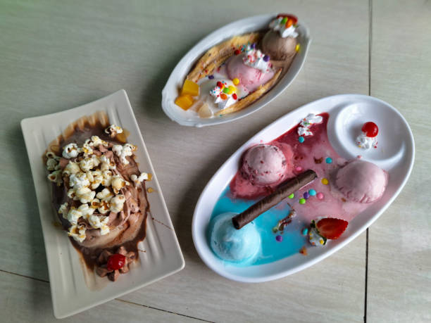 Delocomotion With Choco Chips, Ice Cream, Chocolate PopCorn And Cherry. Ice Cream With Candy, Strawberry Fruit And Chocolate Stick. Banana Split Ice Cream With Banana, Strawberry, Mango, Whipped Cream, Candy, Chocolate Strawberry Vanilla Ice Cream.