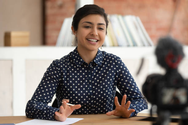 istock Millennial indian female coach recording video training course 2202464137