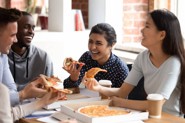 istock Smiling multiethnic students have fun enjoying pizza lunch break 2202465345