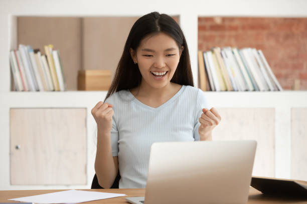 istock Excited Asian female student feel euphoric getting high grade 2202465792
