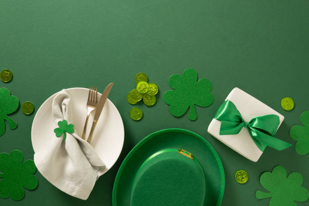 istock St Patrick's Day table setting with white plate and clover leaves on green. 2202466355