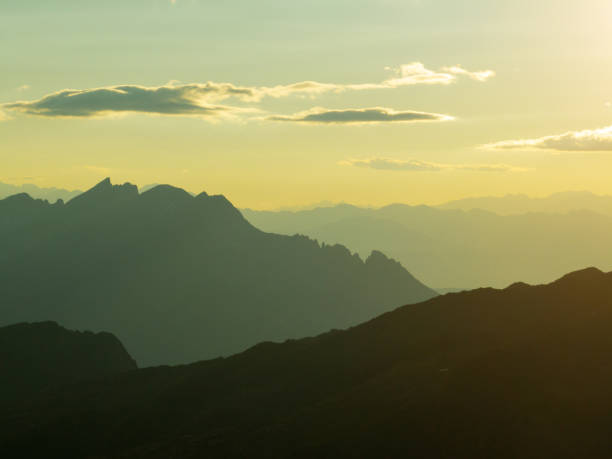 istock Majestic Dolomites during sunrise, mist softening mountain ridges, creating ethereal depth. Light highlights rugged peaks, warm golden glow enhances tranquil landscape. Adventure, nature, scenic. Travel 2202466815