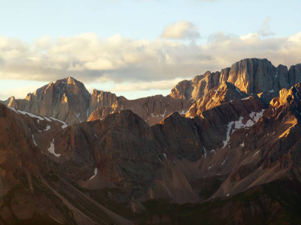 istock Majestic Dolomites during sunrise, mist softening mountain ridges, creating ethereal depth. Light highlights rugged peaks, warm golden glow enhances tranquil landscape. Adventure, nature, scenic. Travel 2202466816