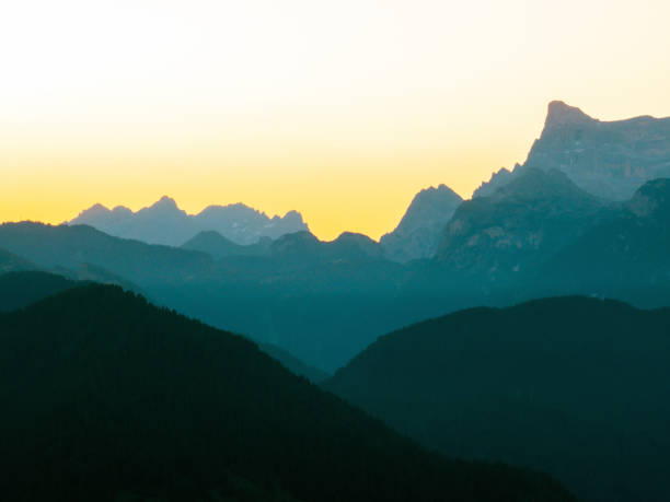 istock Breathtaking mountain scenery, Dolomites glowing warm sunlight. Peaks rise aerial view, casting dramatic shadows. Atmosphere makes perfect for travel, outdoor adventures, nature appreciation, getaways 2202466850